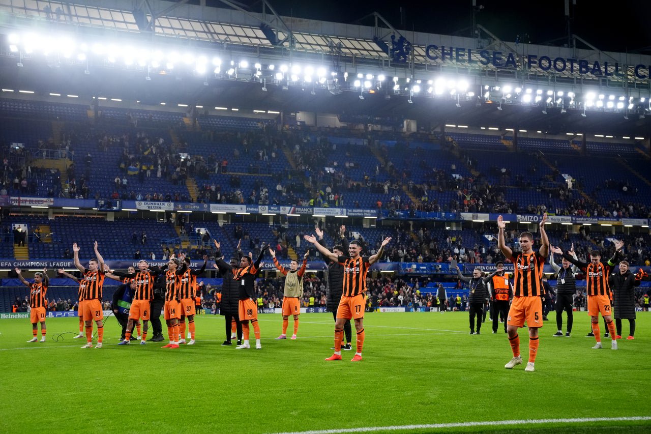 Shakhtar players lead a 'Viking Thunder Clap' celebration with their supporters after their victory (PA)