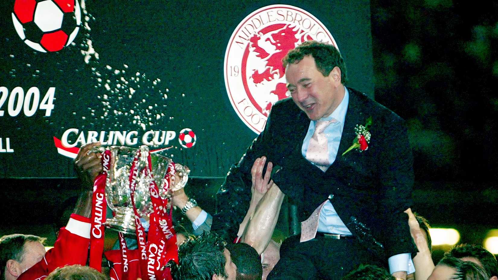 Middlesbrough's Chairman Steve Gibson (top R) is lifted by players as they celebrate winning the League Cup trophy after their final against Bolton Wanderers at the Millennium Stadium in Cardiff