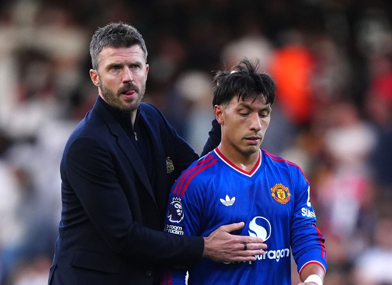 Manchester United manager Michael Carrick with Lisandro Martinez