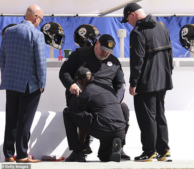 Steelers coach Mike McCarthy (center) injured his ankle during the game against Tampa Bay