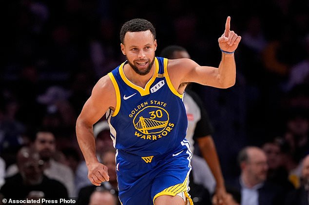 Golden State Warriors guard Stephen Curry gestures after scoring during the first half of an NBA basketball game against the Los Angeles Lakers, Wednesday, Oct. 21, 2026, in Los Angeles. (AP Photo/Mark J. Terrill)