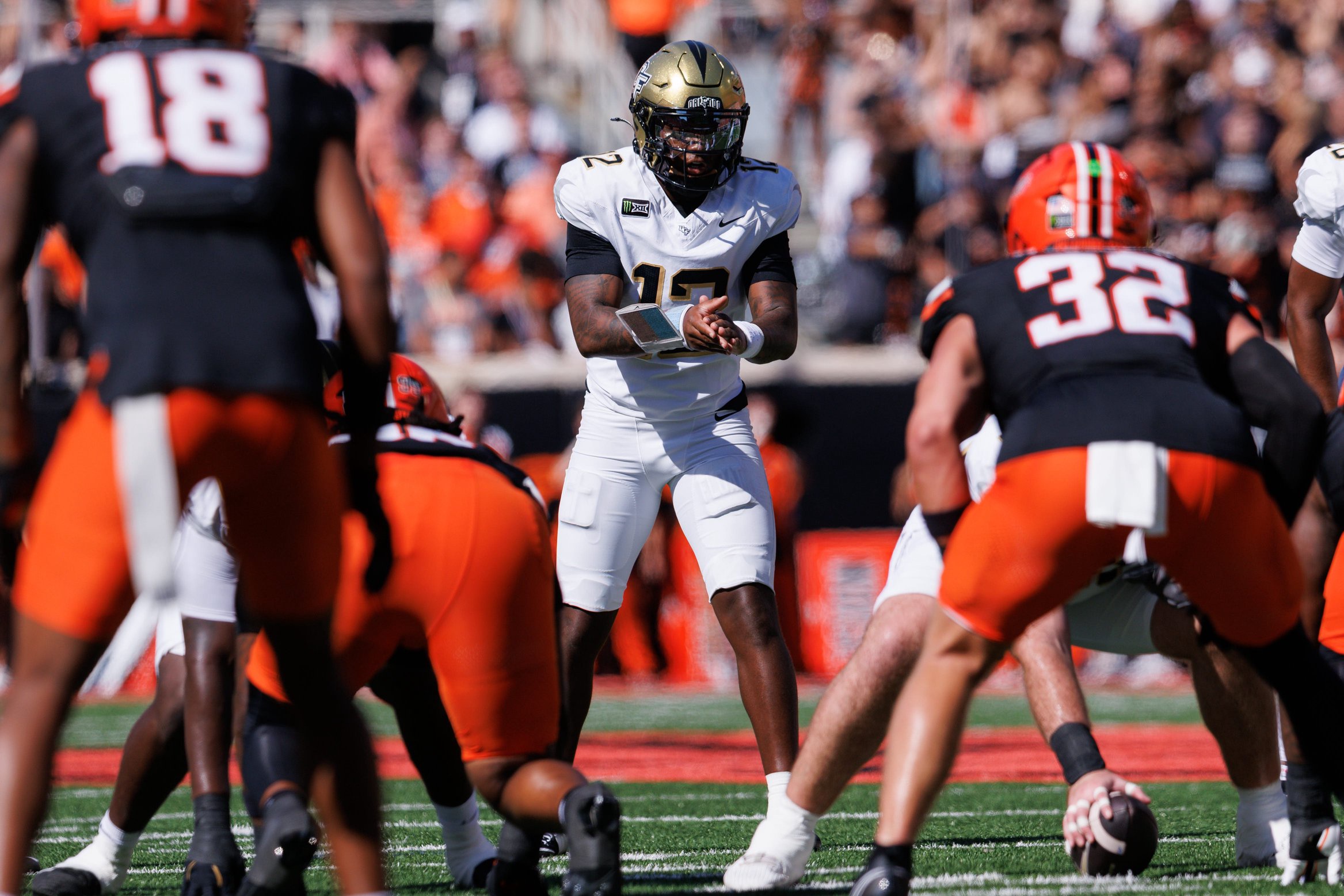 Oct 10, 2026; Stillwater, Oklahoma, USA;  UCF Knights quarterback Keyone Jenkins (12) behind the line during the first half against the Oklahoma State Cowboys at Boone Pickens Stadium.  Mandatory Credit: William Purnell-Imagn Images