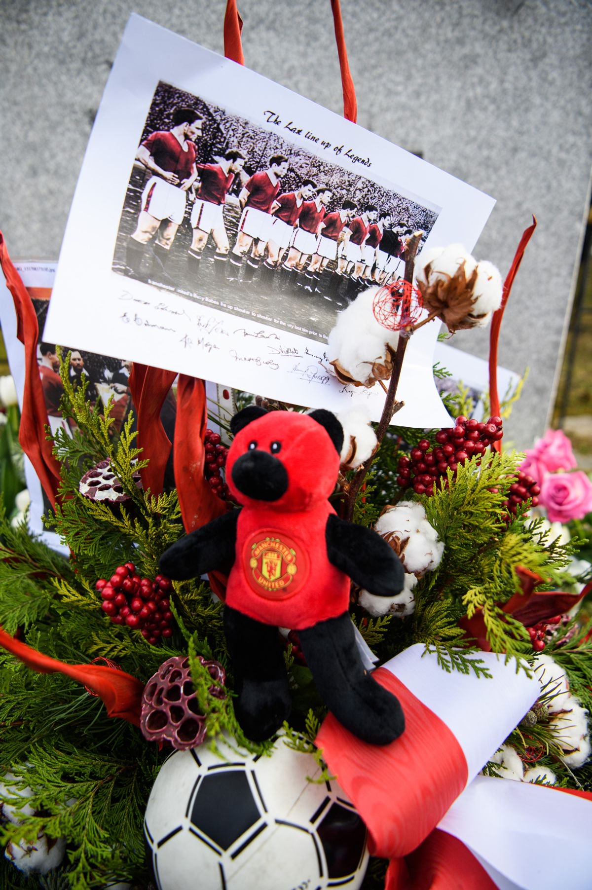 Flowers lie in front of a memorial stone commemorating the Munich air disaster