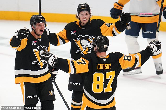 Pittsburgh Penguins' Rickard Rakell (67) celebrates after his goal with Ville Koivunen (41) and Sidney Crosby (87) during the third period of an NHL hockey game against the Nashville Predators in Pittsburgh, Saturday, Oct. 24, 2026. (AP Photo/Gene J. Puskar)