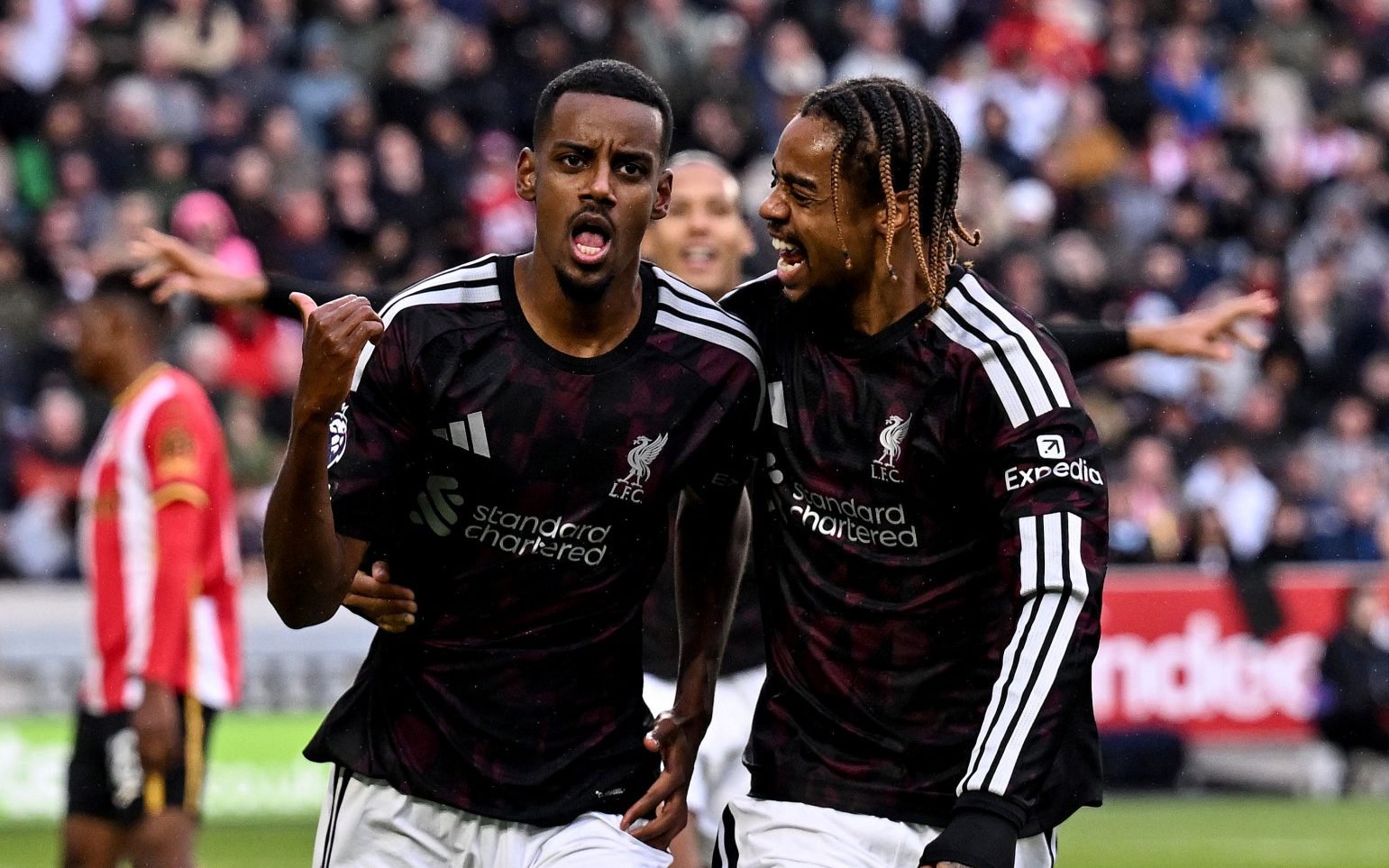 Alexander Isak of Liverpool celebrating with Bradley Barcola
