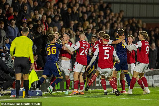 An incensed Dowman grapples with the Fleetwood Town players just before being sent off on Tuesday night