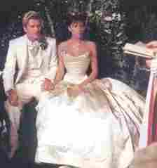 Posh and Becks holding hands for the ceremony