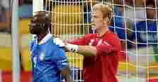 Italy striker Mario Balotelli with England goalkeeper Joe Hart