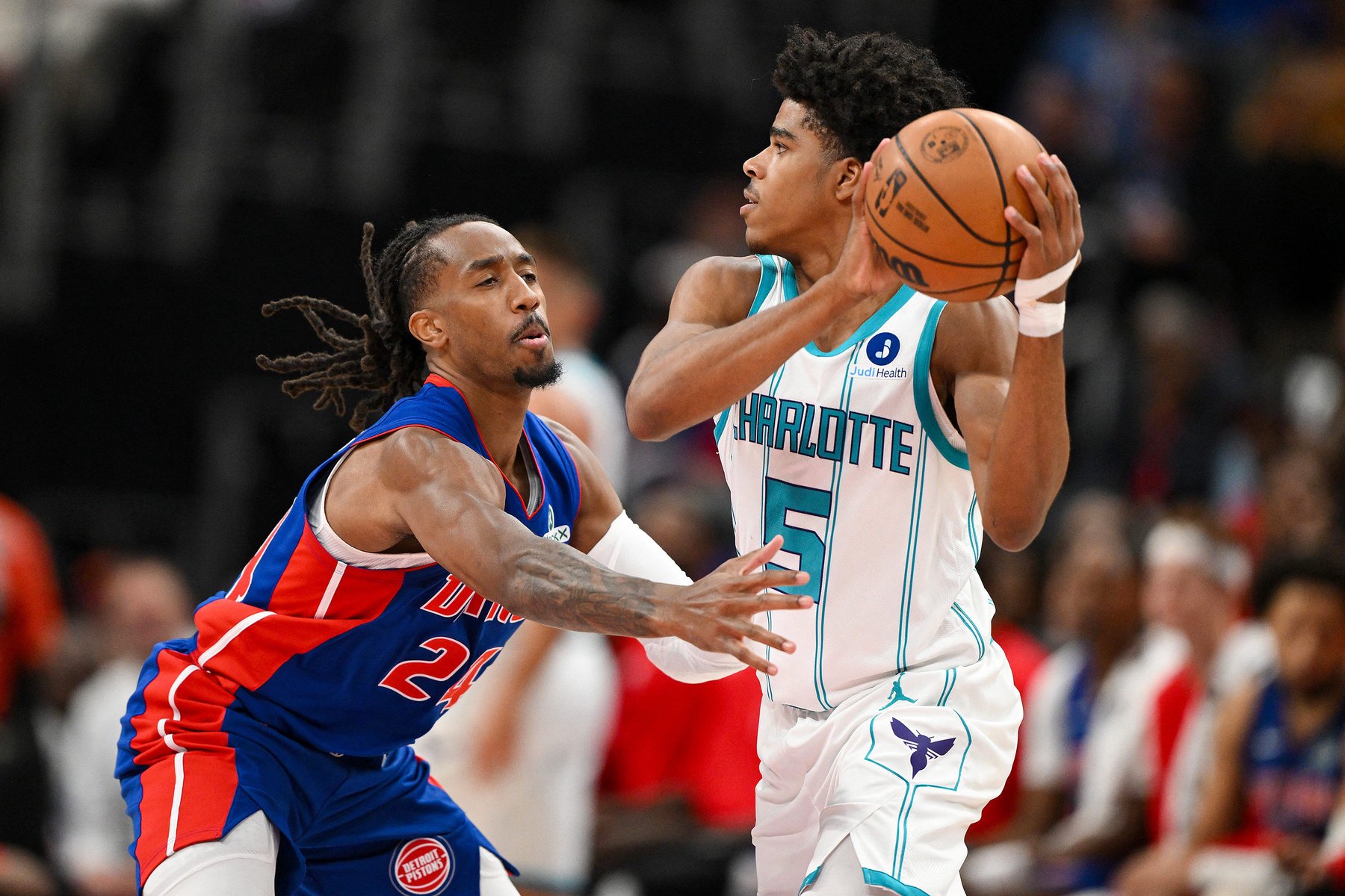 Oct 28, 2026; Detroit, Michigan, USA;  Charlotte Hornets guard Christian Anderson (5) looks to pass the ball while being defended by Detroit Pistons guard Daniss Jenkins (24) in the second half at Little Caesars Arena.  Mandatory Credit: Lon Horwedel-Imagn Images