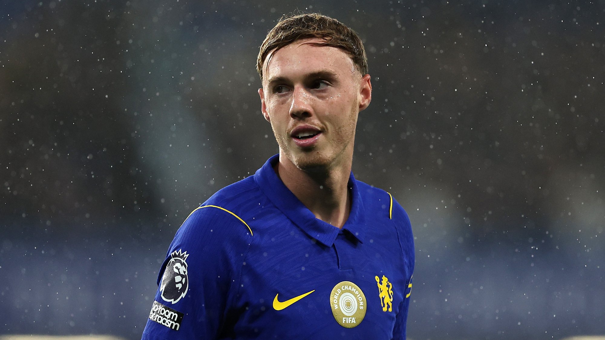 Cole Palmer of Chelsea, smiling, looking onwards.