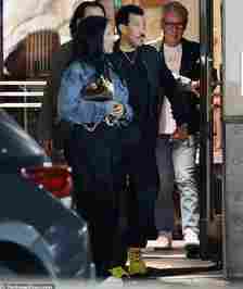 Parigi wore a white bra top underneath a light blue denim jacket as she spent time with her partner