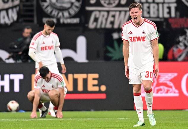 1. FC Köln's Marius Bülter, right, after Eintracht Frankfurt's Younes Ebnoutalib scored a goal during a Bundesliga soccer match, Friday, Oct. 16, 2026, in Frankurt, Germany. (Florian Wiegand/dpa via AP)