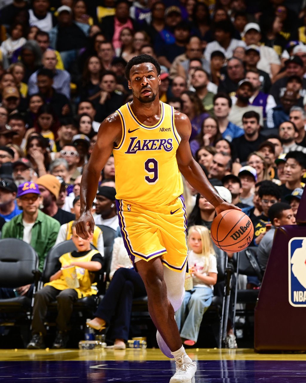 Los Angeles Lakers player Bronny James dribbles the ball during a game against the Denver Nuggets.