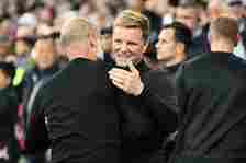 Eddie Howe, Manager of Newcastle United, interacts with Pep Guardiola, Manager of Manchester City, prior to the Premier League match between Manche...