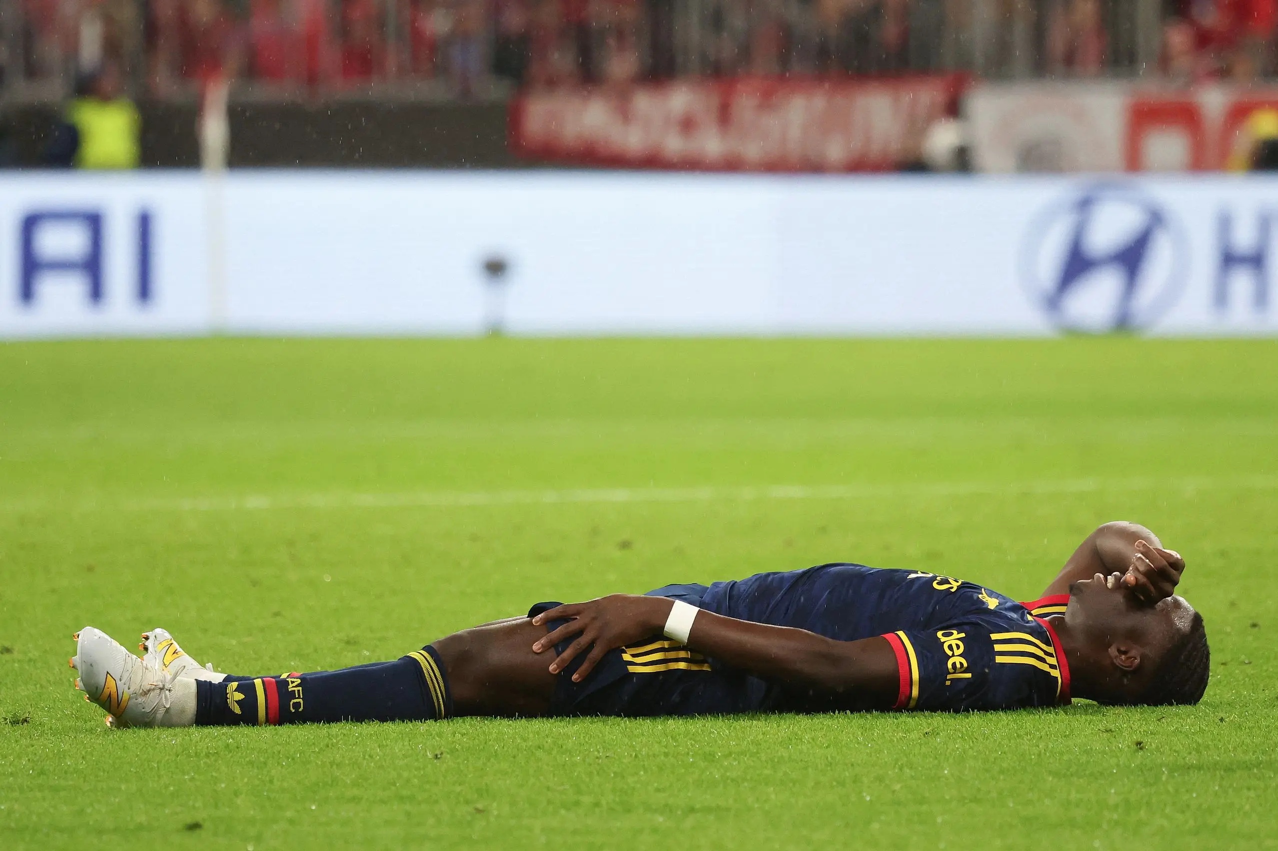 Bukayo Saka reacts after sustaining an injury during the UEFA Champions League.