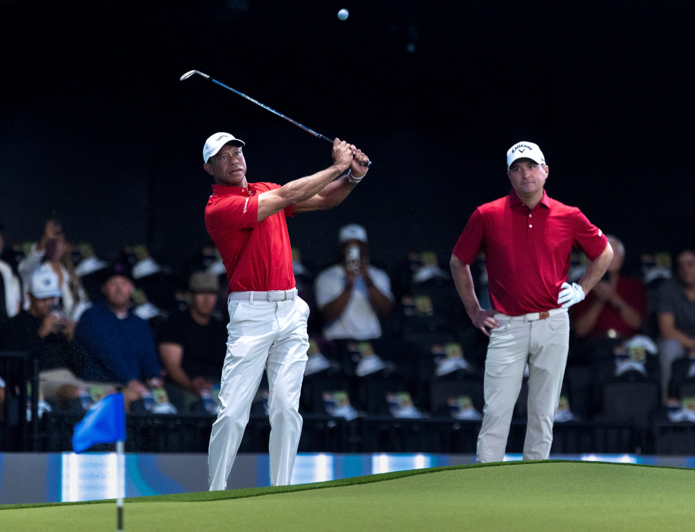 Tiger Woods, hits the ball next to Kevin Kisner of Jupiter Links before a TGL match against New York Golf Club at SoFi Center on January 13, 2026, in Palm Beach Gardens, Florida.
