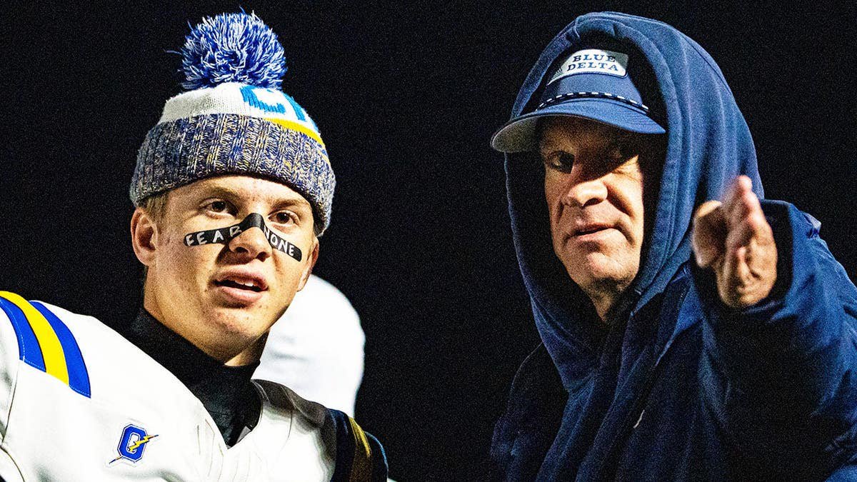 Knox Kiffin talks with his father Lane Kiffin on the sidelines during a high school football game.
