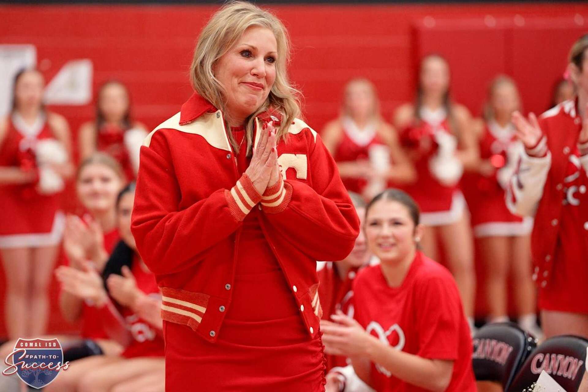 Canyon High School volleyball coach Heather Sanders wears a letterman gifted to her by the son of Ben Hardy, the school’s first principal, athletic director and head coach, during the "Forever Red" event honoring generations of Canyon volleyball players and coaches.