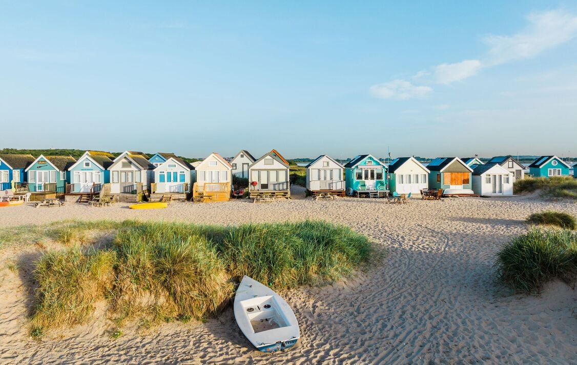 A dawn view of colourful beach huts, Bournemouth