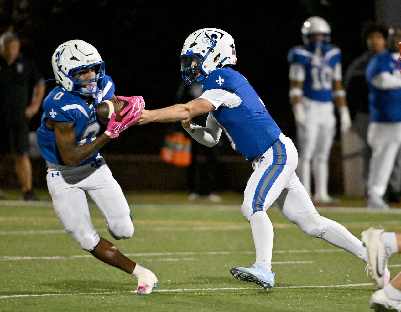 St. Mary's Saints DJ Hitaffer #3 hands off to Karter Pack #0 during the second quarter. The Archbishop Spalding Cavaliers visit the St. Mary\xe2\x80\x99s Saints in a high school football matchup Friday evening. (Paul W. Gillespie/Staff)