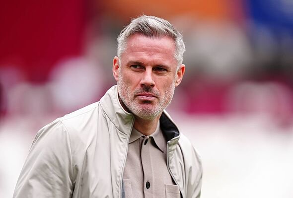 An individual with a composed demeanor is seen standing in an open field. The person is clad in a light-colored jacket, possibly