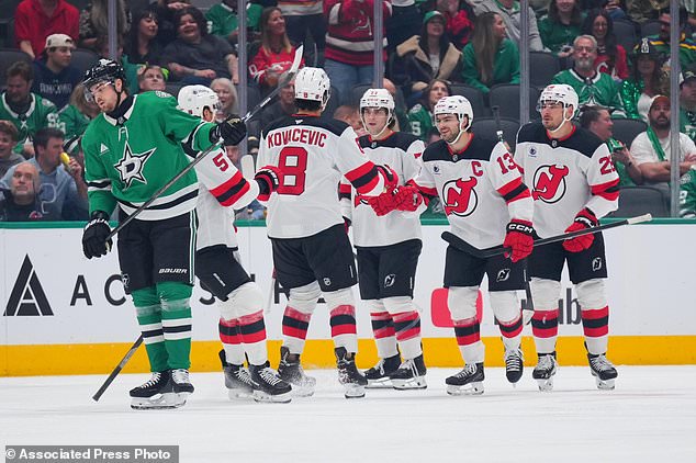 New Jersey Devils center Nico Hischier (13) celebrates after scoring a goal against the Dallas Stars during the first period of an NHL hockey game Tuesday, Oct. 27, 2026, in Dallas. (AP Photo/Julio Cortez)