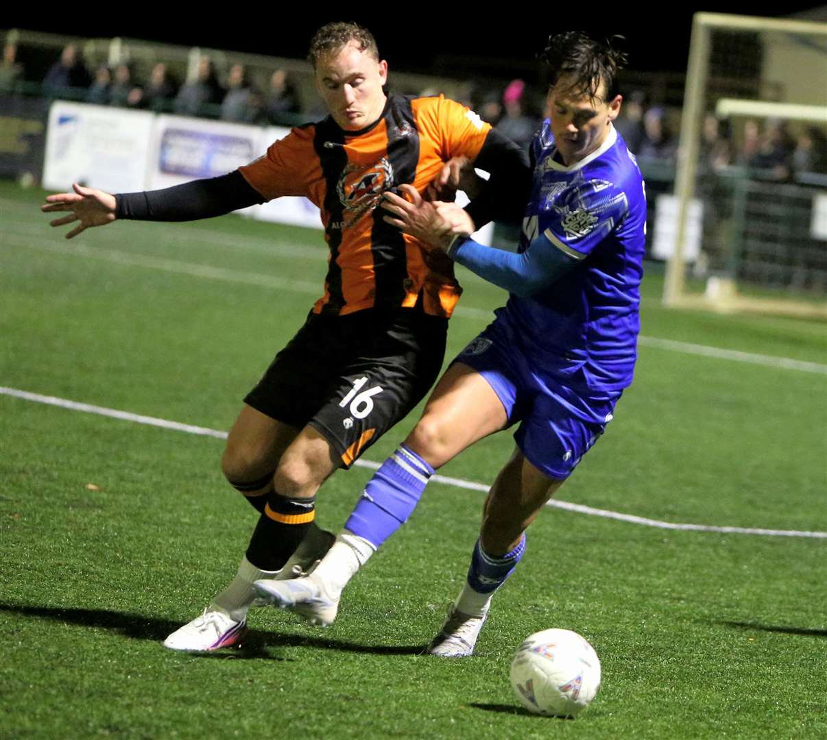 Folkestone’s Adam Lovatt puts Tonbridge Angels’ striker Alfie Pavey under pressure in the midweek derby at Longmead. Picture: David Couldridge