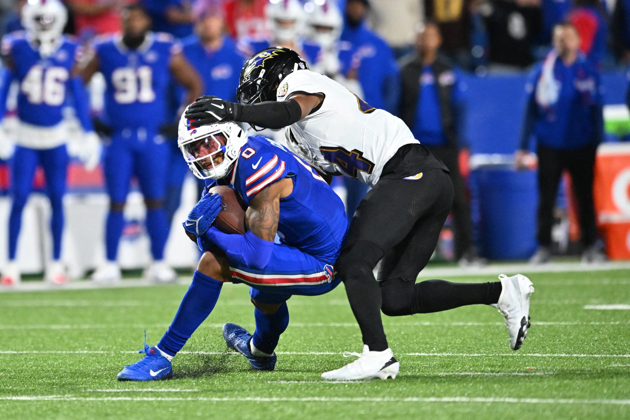 Sep 7, 2025; Orchard Park, New York, USA;  Baltimore Ravens wide receiver Zay Flowers (4) defends against Buffalo Bills wide receiver Keon Coleman (0) during the fourth quarter at Highmark Stadium. Mandatory Credit: Mark Konezny-Imagn Images