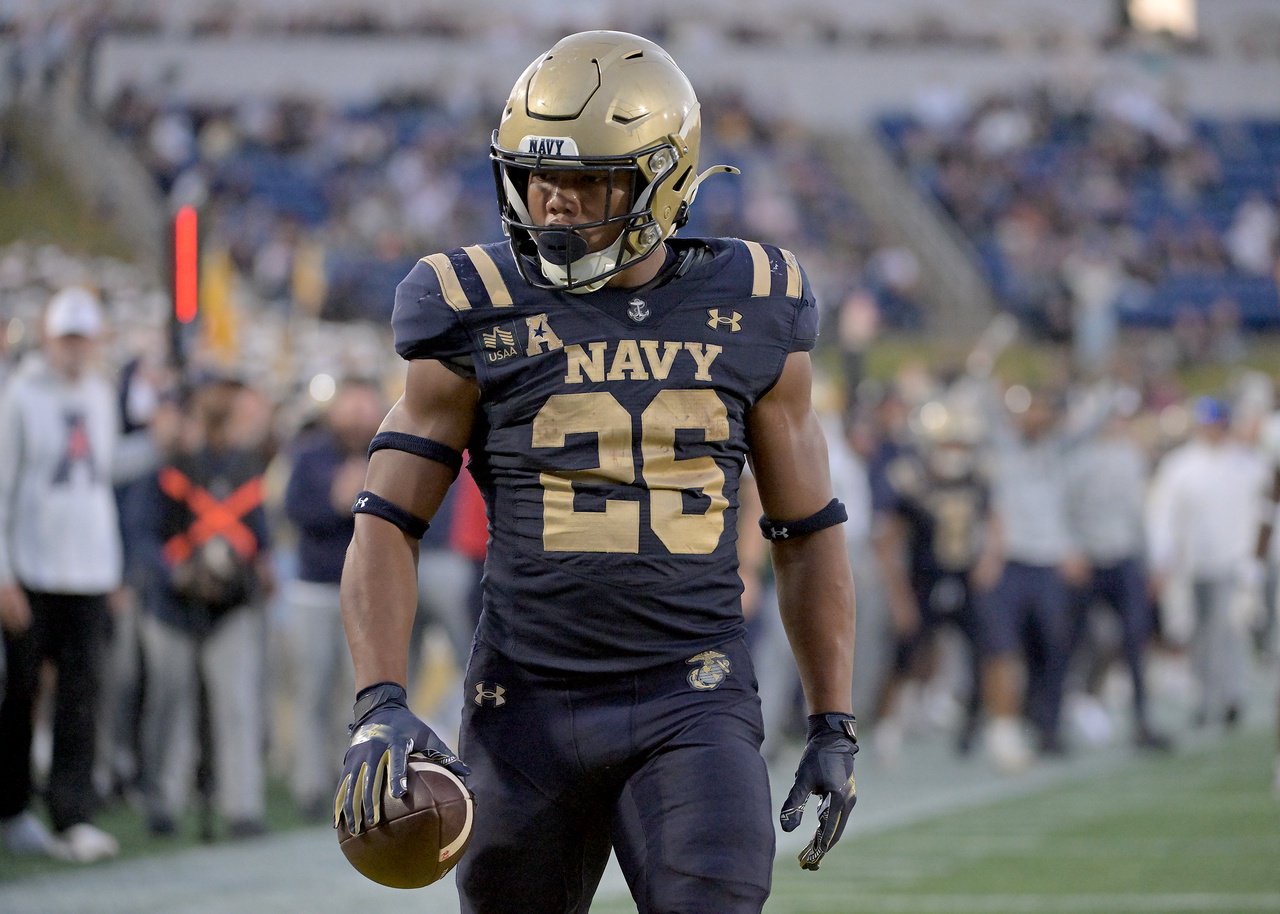Navy Midshipmen running back Michael Barrow #26 stares down a defender after making a big touchdown catch in the third quarter. The visiting North Texas Mean Green defeat the Navy Midshipmen, 49-39, in an NCAA football game Saturday at Navy-Marine Corps Memorial Stadium in Annapolis. (Paul W. Gillespie/Staff)
