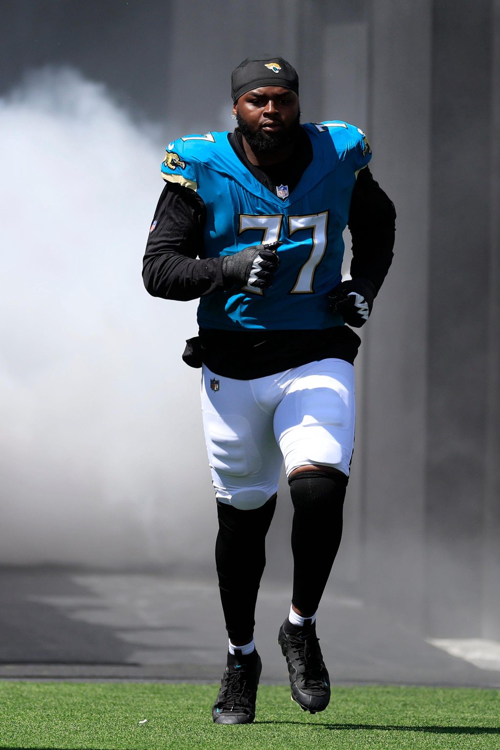 Jacksonville Jaguars offensive tackle Anton Harrison (77) is introduced before an NFL football matchup at EverBank Stadium.