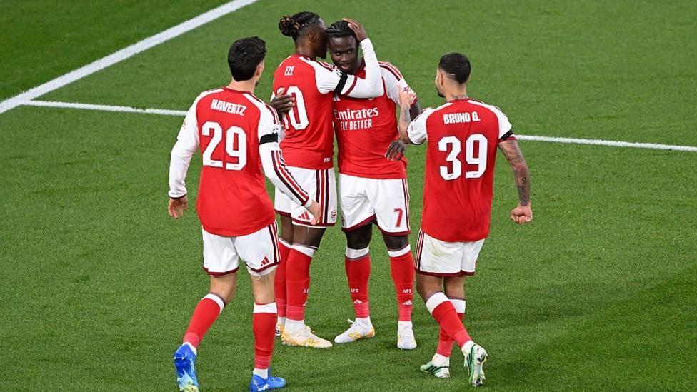 Arsenal players celebrate their goal.
