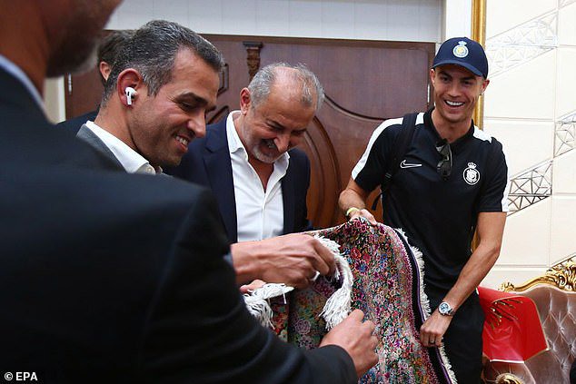 The Portuguese star looked delighted to receive a Persian rug from Persepolis as a present