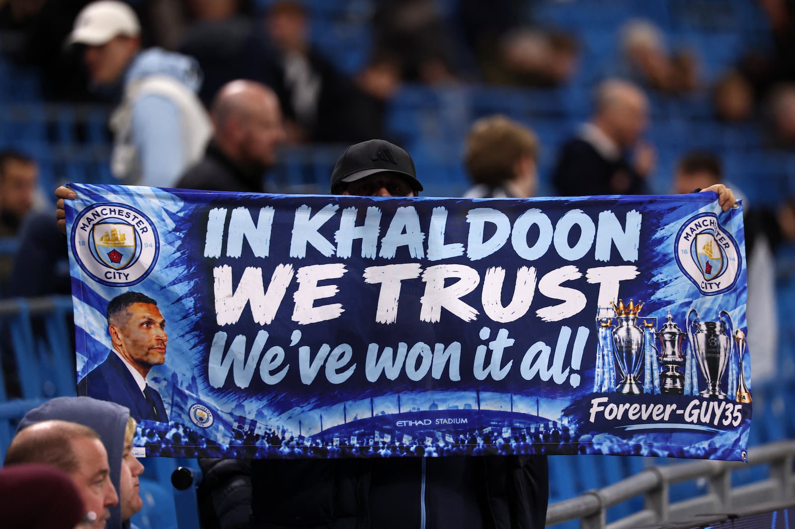 A City fan displays a flag with a slogan in support of Manchester City's Emirati chairman Khaldoon al-Mubarak. Photograph: Franck Fife/AFP via Getty Images