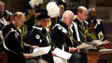 Prince William, Queen Camilla, King Charles III, and Prince Edward sitting in ceremonial robes in a church