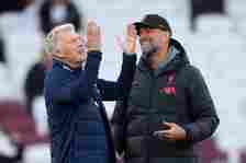 David Moyes, Manager of West Ham United, and Juergen Klopp, Manager of Liverpool, speak during the warm up prior to the Premier League match betwee...