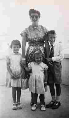 Mary Tisdall with her children Roger, Susan and Bridget, aged seven, five and two in Jordan as part of their trek across the world to see her husband