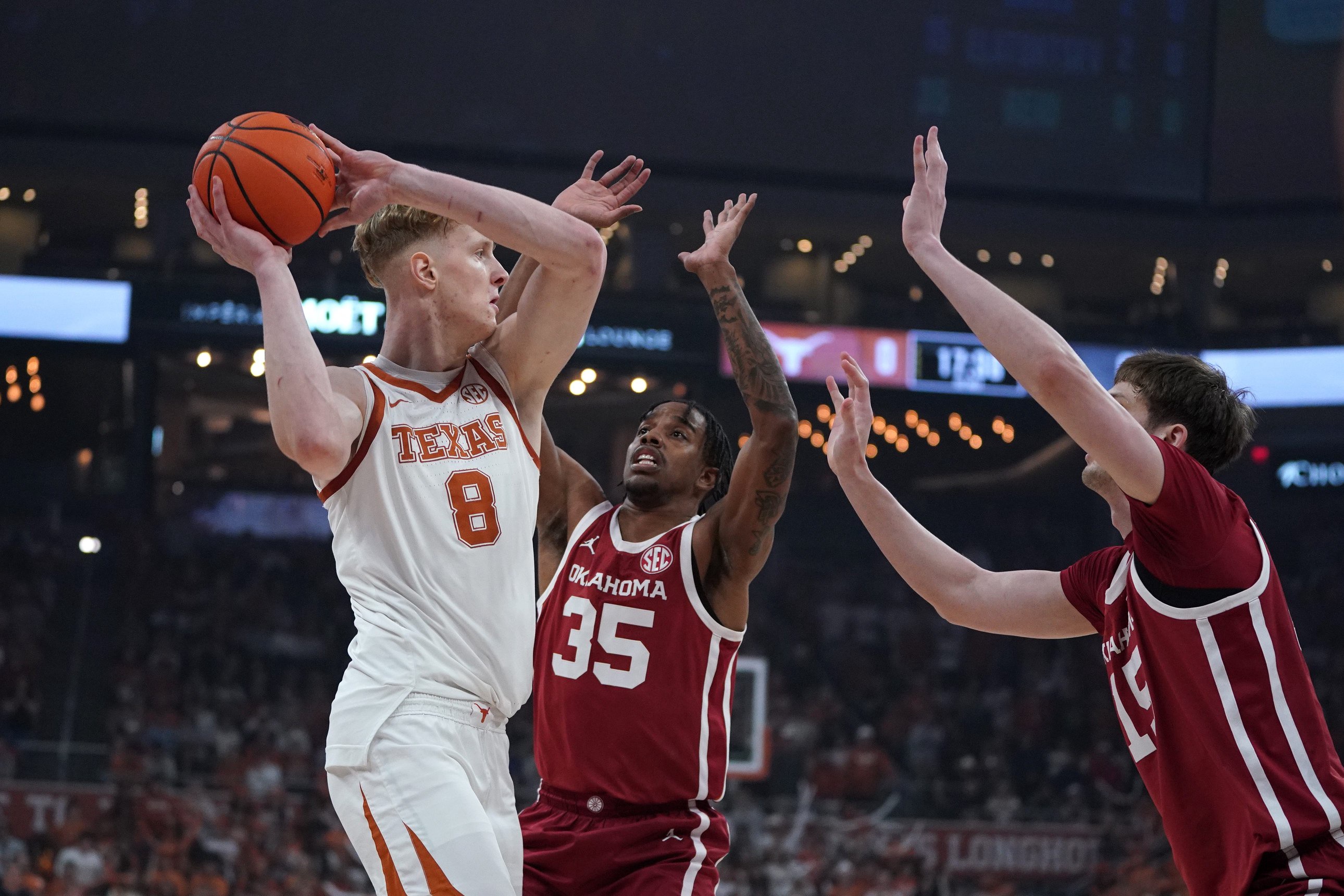 Mar 7, 2026; Austin, Texas, USA; Texas Longhorns center Matas Vokietaitis (8) looks to pass againats Oklahoma Sooners forward Derrion Reid (35) and center Kirill Elatontsev (15) during the first half at Moody Center. Mandatory Credit: Dustin Safranek-Imagn Images