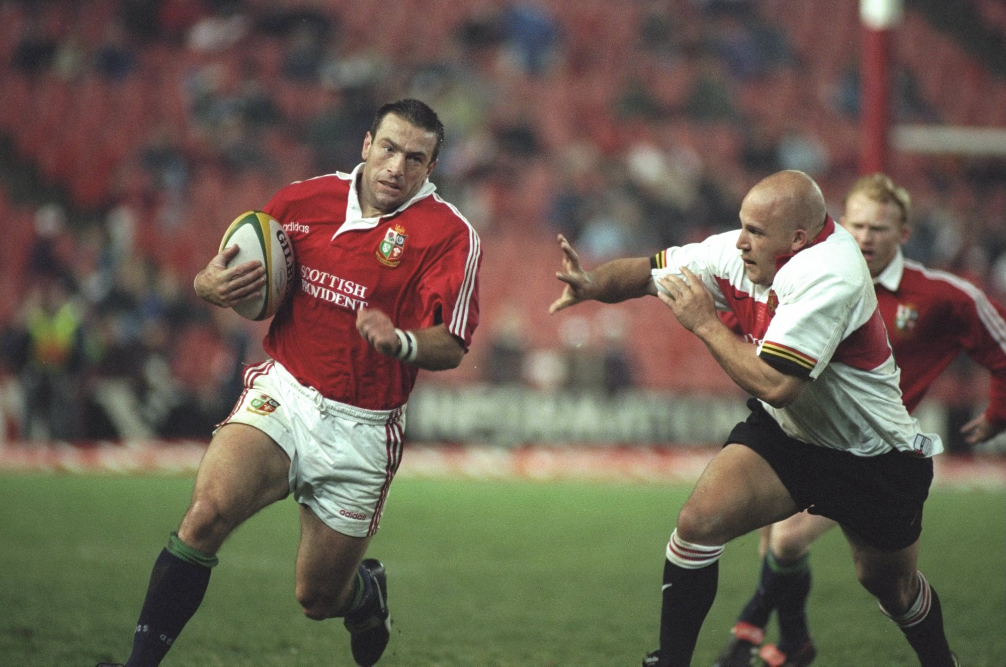 The British & Irish Lions' John Bentley runs past Guateng defenders during a 1997 tour match in South Africa