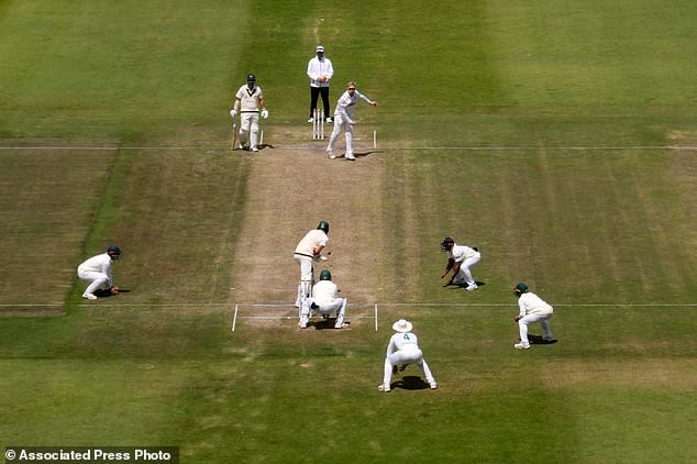 South Africa's Simon Harmer, center top, bowls during day five of the second cricket test match between South Africa and Australia in Gqeberha, South Africa, Thursday, Oct. 22, 2026. (AP Photo/Themba Hadebe)