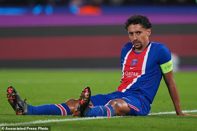 PSG's Marquinhos, right, sits on the field after appearing to suffer an injury during the Champions League opening phase soccer match between Paris Saint-Germain and FC Barcelona in Paris, Tuesday, Oct. 20, 2026. (AP Photo/Thibault Camus)