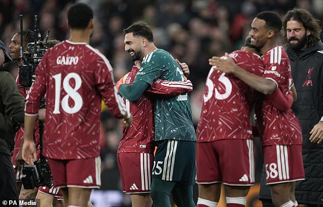 Liverpool goalkeeper Giorgi Mamardashvili (centre) celebrates with his team mates after the penalty shoot out win over Chelsea in the Carabao Cup (Peter Byrne/PA).