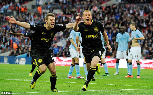 Watson (right) celebrates sending Wigan towards the first major trophy in their history