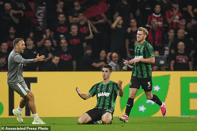 Sassuolo's Cas Odenthal celebrates after scoring during the Serie A soccer match between Sassuolo and AC Milan, in Reggio Emilia, Italy, Sunday, Oct.11, 2026. (Massimo Paolone/LaPresse via AP)