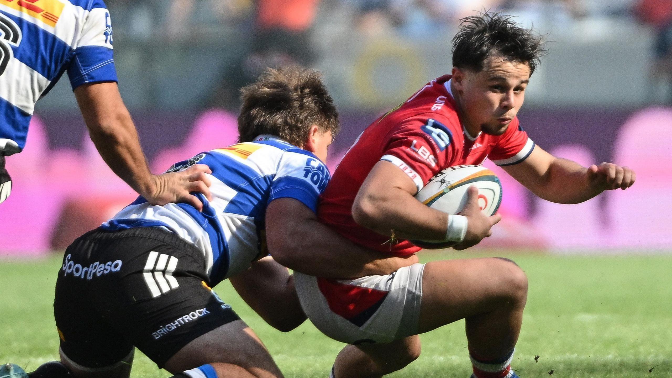 Scarlets' Carwyn Leggatt-Jones is tackled by Markus Muller of the DHL Stormers
