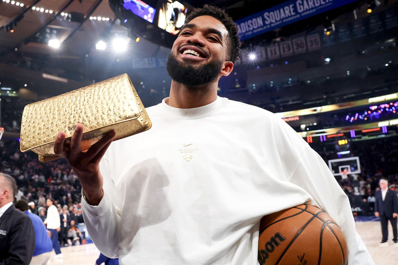 Karl-Anthony Towns #32 of the New York Knicks poses with Jordyn Woods-Towns’ Limited Edition Tux Clutch Mini on Oct. 20, 2026.Credit: Sarah Stier/Getty