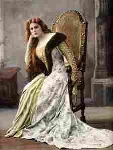 A portrait of an actress portraying Margaret of Burgendy sitting in a chair