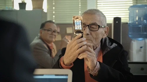 An old man using a phone