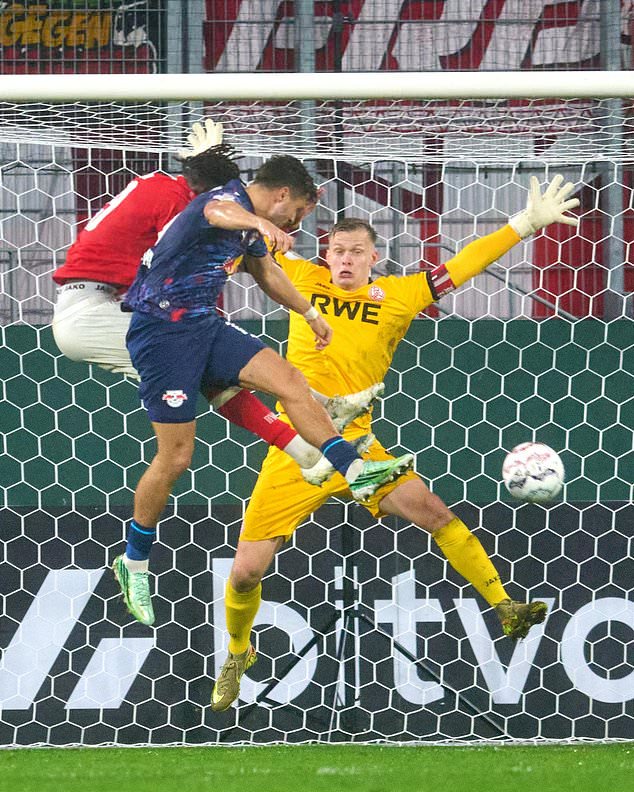 Leipzig's Christoph Baumgartner, foreground, scores a goal past Essen goalkeeper Jakob Golz during the German soccer cup match between Rot Weiss Essen and RB Leipzig in Essen, Germany, Tuesday, Oct. 27, 2026. (Bernd Thissen/dpa via AP)