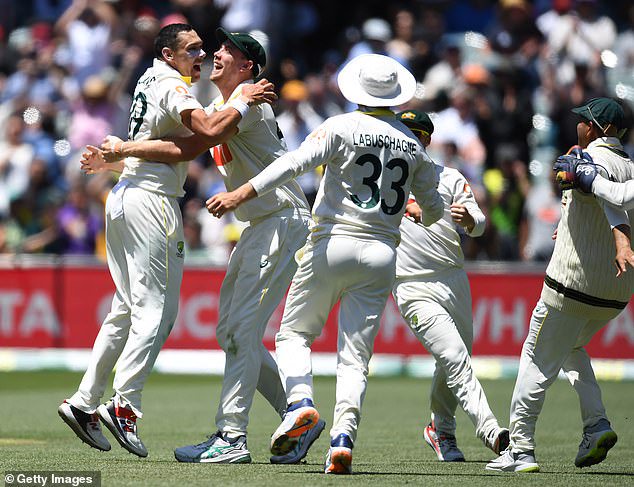 Pictured: Scott Boland (left) and his teammates celebrate after he took Josh Tongue's wicket to win the series for Australia