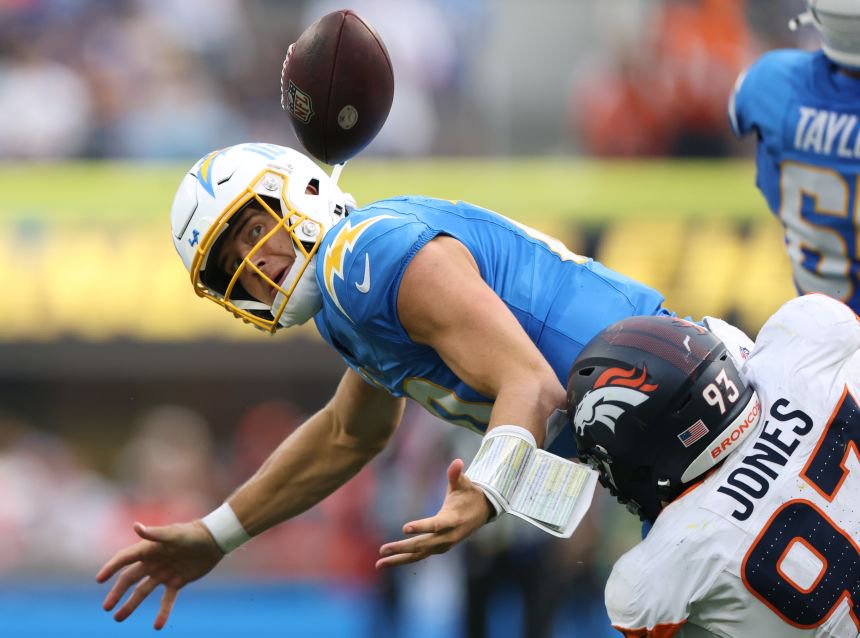 Los Angeles Chargers quarterback Justin Herbert eyes his own fumble as he is sacked by Denver's DJ Jones earlier this month.